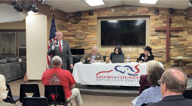 A speaker at the microphone opening the Adams County Republican Party meeting