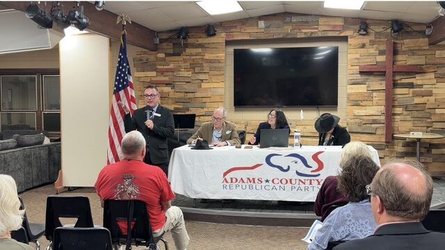 A speaker at the head table with the Adams County Republican Party banner