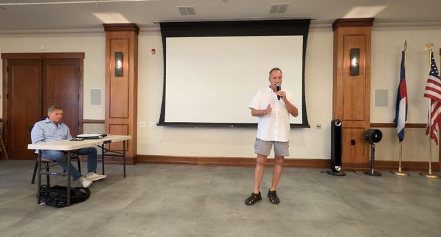 Paul speaking to the club, microphone in hand