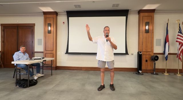 Paul speaking from the front of the room