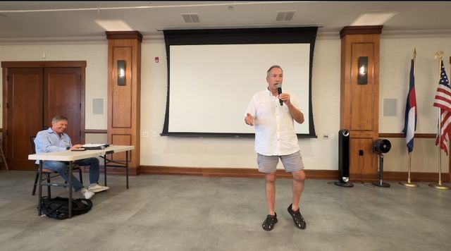 Paul raising a hand while he speaks