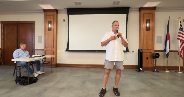 Paul at the front of the room with the microphone