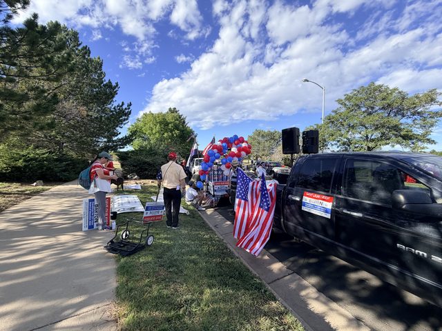 The float and flags along the curb before the parade