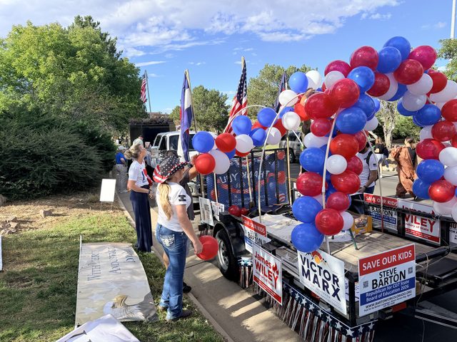 Candidate signs on the float under the balloon arch
