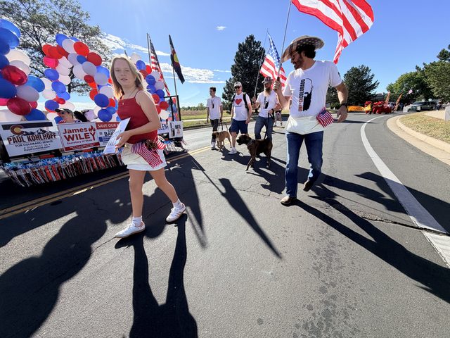 Marchers with flags and signs on Midway Boulevard