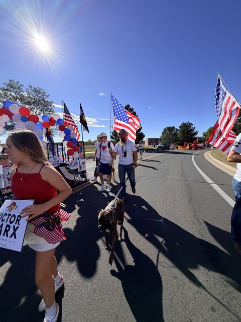 Marchers with signs in the morning sun