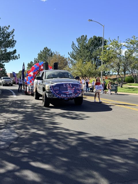 The truck coming up the route with marchers behind it