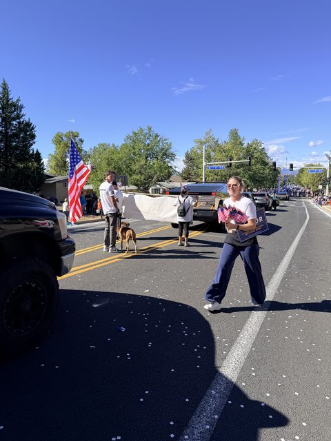 A marcher with a dog and a flag
