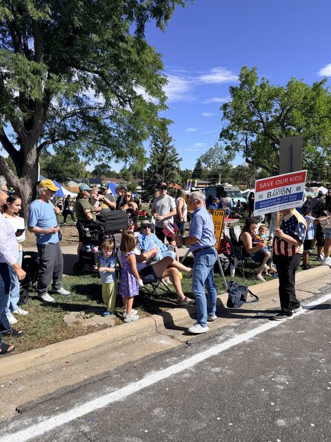Spectators lined up on the curb at Midway Park